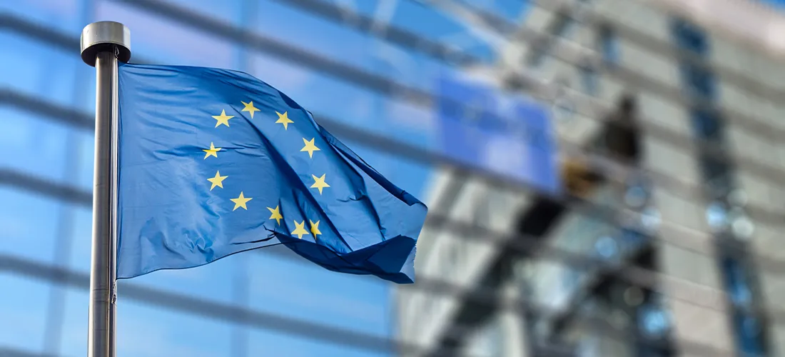 eu flag waving in front of the european commission building