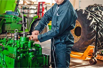 A person calibrating agriculture machinery and equipment