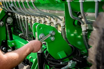 A person calibrating agriculture machinery and equipment