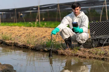 technical men checking growndwater for contamination, using all the appopriate IPE's