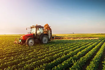 tractor applying pesticide in a soybean field